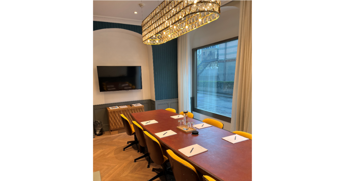 A boardroom large dark wooden table
